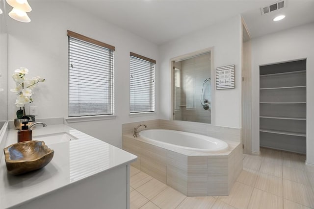 400 Saturnia Dr, Georgetown, TX 78613 - full bathroom with a garden tub, tile patterned flooring, double vanity, and a shower