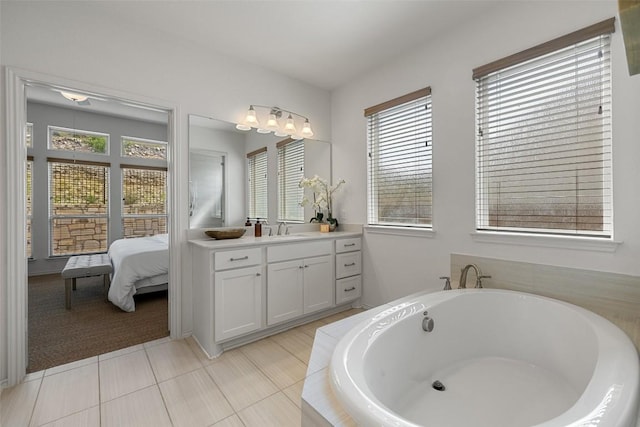 400 Saturnia Dr, Georgetown, TX 78613 - full bath featuring vanity, a tub, connected bathroom, and tile patterned flooring