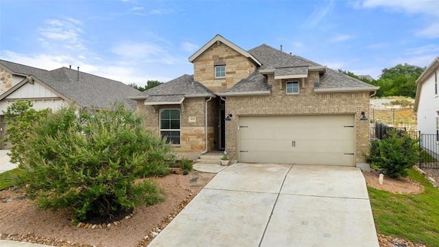 400 Saturnia Dr, Georgetown, TX 78613 - french provincial home featuring a shingled roof, concrete driveway, a garage, brick siding, and stone siding