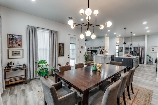 410 Woodland Oaks Trl, Buda, TX 78610 - dining space featuring light wood-type flooring, recessed lighting, and a chandelier