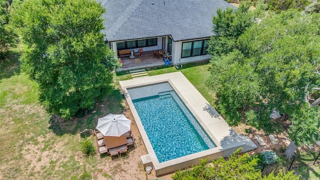 410 Woodland Oaks Trl, Buda, TX 78610 - back of house with an outdoor pool, a wooden deck, and a shingled roof