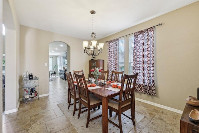 1312 Ravensbrook Bnd, Cedar Park, TX 78613 - dining room with arched walkways, a chandelier, and baseboards