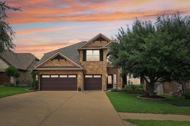 1312 Ravensbrook Bnd, Cedar Park, TX 78613 - view of front facade with driveway, a yard, stone siding, and a garage