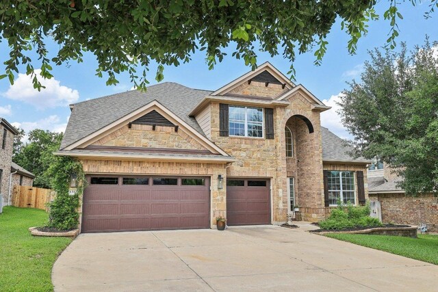 1312 Ravensbrook Bnd, Cedar Park, TX 78613 - traditional-style home featuring stone siding, driveway, and roof with shingles