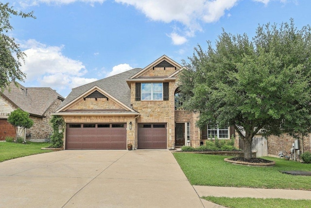 1312 Ravensbrook Bnd, Cedar Park, TX 78613 - view of front facade with driveway, stone siding, a front yard, and an attached garage