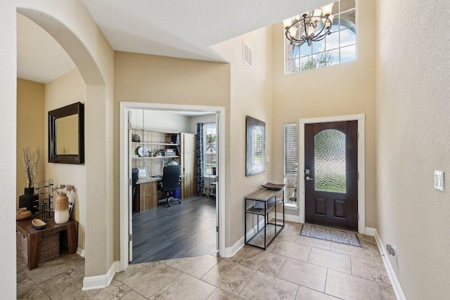 1312 Ravensbrook Bnd, Cedar Park, TX 78613 - tiled foyer with healthy amount of natural light, a chandelier, and baseboards