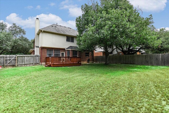 13022 Hunters Chase Dr, Austin, TX 78729 - rear view of property with brick siding, a wooden deck, a chimney, and roof with shingles