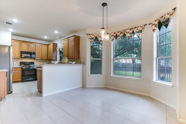 13022 Hunters Chase Dr, Austin, TX 78729 - kitchen featuring black appliances, backsplash, light countertops, brown cabinetry, and decorative light fixtures