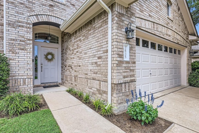 2835 Checker Dr, Cedar Park, TX 78613 - view of exterior entry featuring a garage, driveway, and brick siding