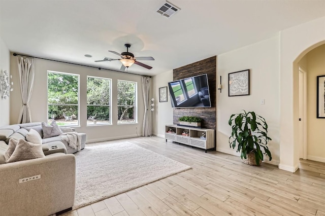 2835 Checker Dr, Cedar Park, TX 78613 - living room with arched walkways, a ceiling fan, and light wood-type flooring