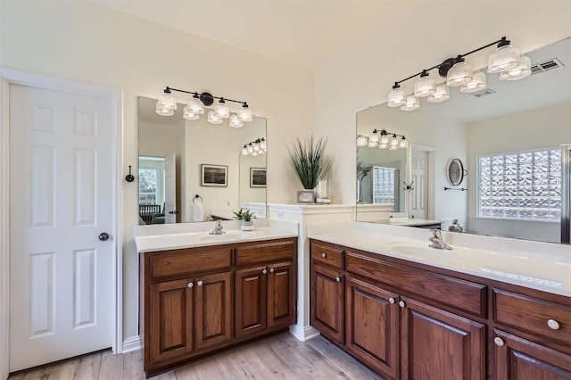 2835 Checker Dr, Cedar Park, TX 78613 - bathroom with two vanities and wood finished floors