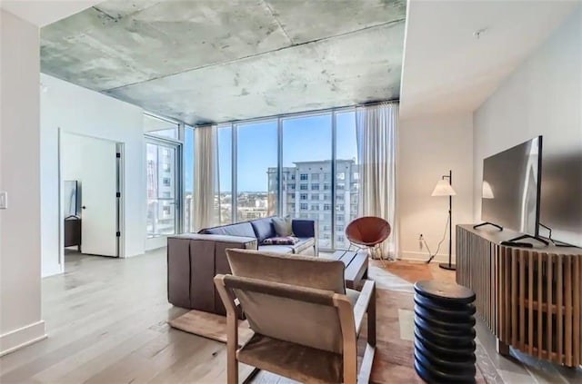 48 E Ave Unit 1210, Austin, TX 78701 - living area featuring light wood-style flooring and a wall of windows