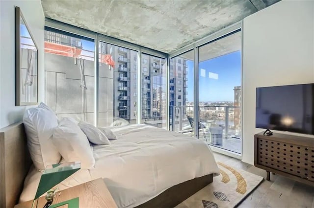 48 E Ave Unit 1210, Austin, TX 78701 - bedroom featuring expansive windows and access to exterior