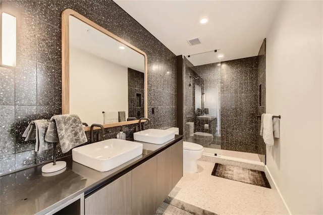48 E Ave Unit 1210, Austin, TX 78701 - full bathroom with a stall shower, double vanity, recessed lighting, and tile walls