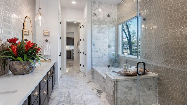 1912 Asti Ln, Leander, TX 78641 - bathroom with marble tiled flooring, double vanity, a garden tub, and healthy amount of natural light