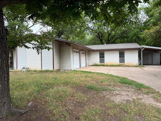 620 Amesbury Ln, Austin, TX 78752 - view of front of house featuring brick siding, driveway, and an attached garage