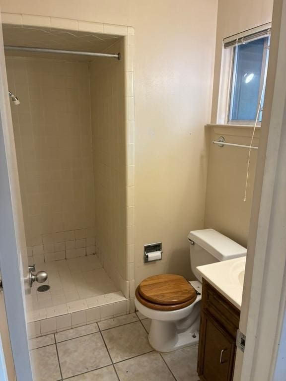 620 Amesbury Ln, Austin, TX 78752 - full bathroom featuring a shower stall, vanity, toilet, and tile patterned flooring