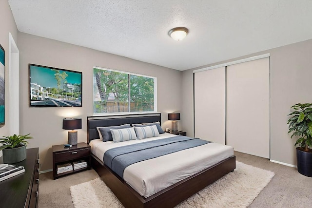 2508 Dovemeadow Dr, Austin, TX 78744 - bedroom featuring light colored carpet, a closet, and a textured ceiling
