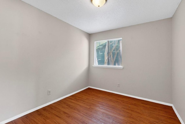 2508 Dovemeadow Dr, Austin, TX 78744 - spare room with wood finished floors and a textured ceiling