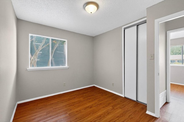 2508 Dovemeadow Dr, Austin, TX 78744 - unfurnished bedroom featuring a closet, wood finished floors, and a textured ceiling