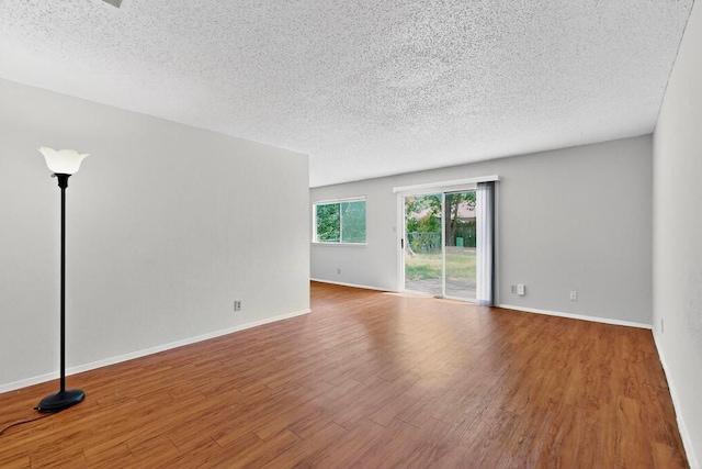 2508 Dovemeadow Dr, Austin, TX 78744 - empty room featuring wood finished floors and a textured ceiling