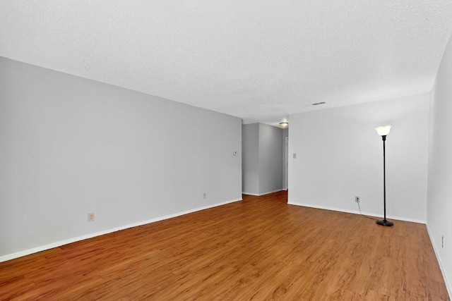 2508 Dovemeadow Dr, Austin, TX 78744 - unfurnished room featuring wood finished floors and a textured ceiling