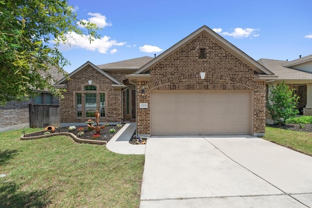 2204 Granite Hill Dr, Leander, TX 78641 - view of front of property featuring brick siding, a garage, concrete driveway, a front yard, and a shingled roof