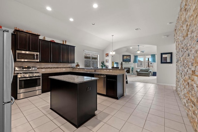 2204 Granite Hill Dr, Leander, TX 78641 - kitchen with appliances with stainless steel finishes, a sink, open floor plan, a kitchen island, and a ceiling fan