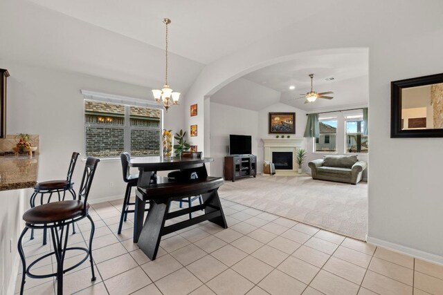 2204 Granite Hill Dr, Leander, TX 78641 - dining room with a ceiling fan, vaulted ceiling, light colored carpet, a chandelier, and light tile patterned floors