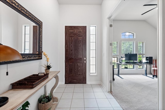 2204 Granite Hill Dr, Leander, TX 78641 - foyer entrance with plenty of natural light, light tile patterned floors, baseboards, light carpet, and vaulted ceiling