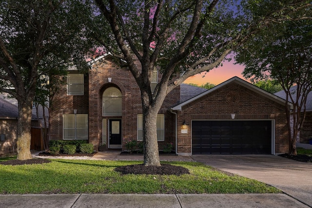 4535 Wandering Vine Trl, Round Rock, TX 78665 - view of front facade with a garage, brick siding, driveway, and a lawn