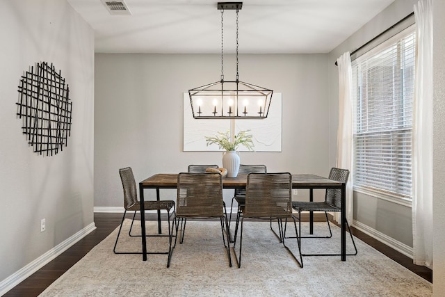 4535 Wandering Vine Trl, Round Rock, TX 78665 - dining space featuring baseboards, dark wood finished floors, and a chandelier