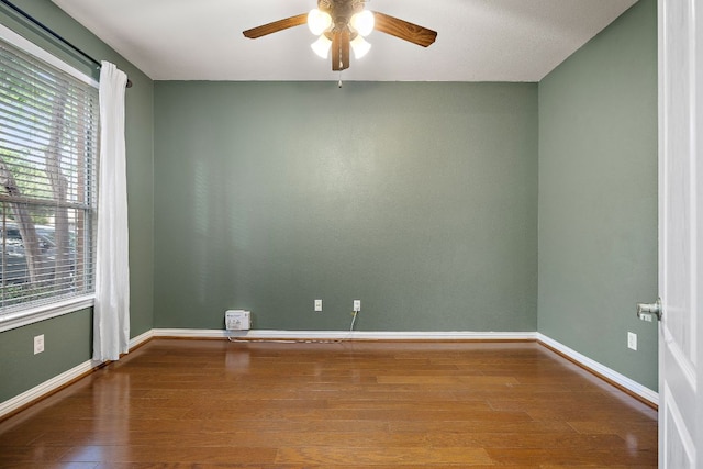 4535 Wandering Vine Trl, Round Rock, TX 78665 - spare room with a ceiling fan, plenty of natural light, wood finished floors, and baseboards
