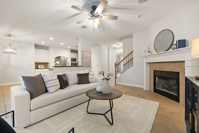4535 Wandering Vine Trl, Round Rock, TX 78665 - living area featuring light tile patterned floors, a ceiling fan, baseboards, recessed lighting, and a tiled fireplace