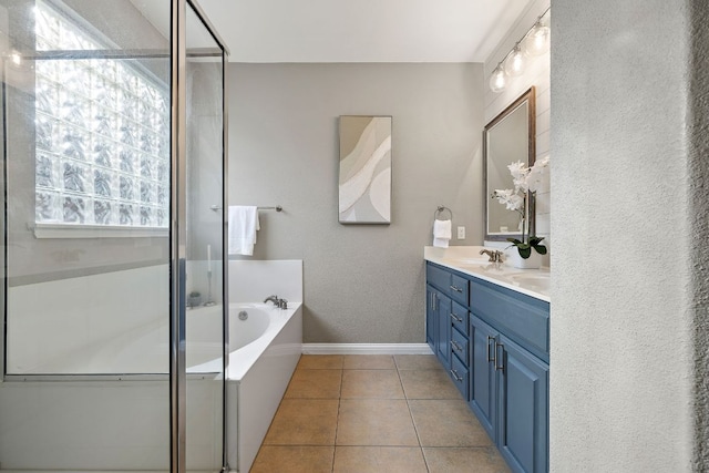 4535 Wandering Vine Trl, Round Rock, TX 78665 - bathroom with double vanity, a bath, a stall shower, tile patterned flooring, and a textured wall