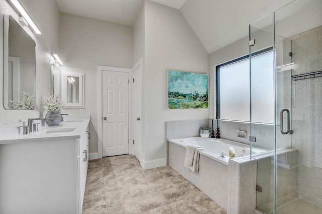 10840 Redmond Rd, Austin, TX 78739 - bathroom with double vanity, a garden tub, a shower stall, vaulted ceiling, and baseboards