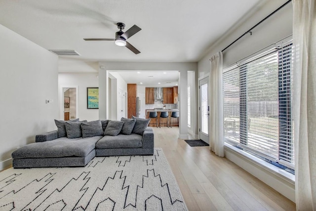 10840 Redmond Rd, Austin, TX 78739 - living area with light wood-style flooring, ceiling fan, and baseboards