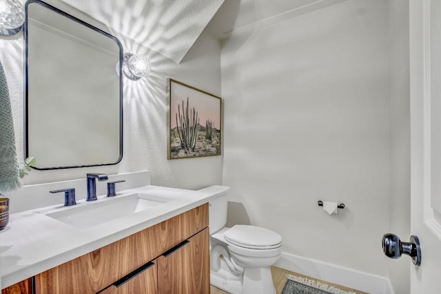 10840 Redmond Rd, Austin, TX 78739 - half bathroom featuring toilet, vanity, and baseboards