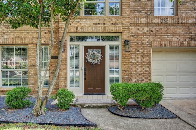 10840 Redmond Rd, Austin, TX 78739 - property entrance featuring brick siding, an attached garage, and driveway