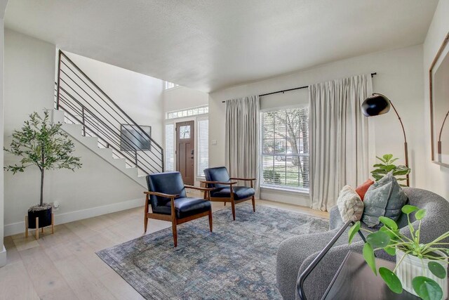 10840 Redmond Rd, Austin, TX 78739 - sitting room featuring plenty of natural light, wood finished floors, stairway, and baseboards
