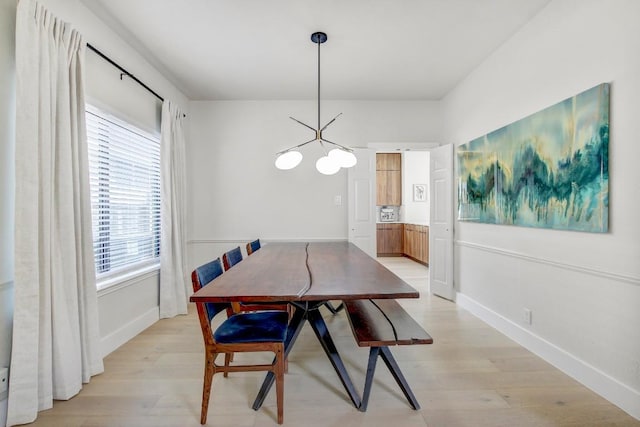 10840 Redmond Rd, Austin, TX 78739 - dining space featuring light wood-type flooring, a chandelier, and baseboards