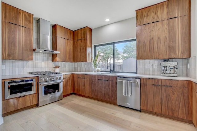 10840 Redmond Rd, Austin, TX 78739 - kitchen with wall chimney exhaust hood, stainless steel appliances, a sink, modern cabinets, and brown cabinetry