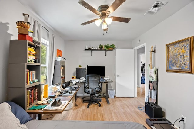 2207 Palmera Cv, Austin, TX 78744 - office featuring a ceiling fan and wood finished floors