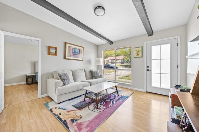 2207 Palmera Cv, Austin, TX 78744 - living area with beam ceiling, light wood-style flooring, and baseboards