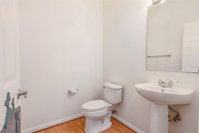287 Red Poppy Trl, Georgetown, TX 78633 - half bathroom featuring wood finished floors, baseboards, and toilet