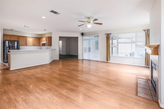 287 Red Poppy Trl, Georgetown, TX 78633 - unfurnished living room with a ceiling fan, light wood-type flooring, recessed lighting, and baseboards
