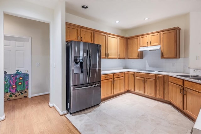 287 Red Poppy Trl, Georgetown, TX 78633 - kitchen featuring fridge with ice dispenser, under cabinet range hood, light countertops, a sink, and decorative backsplash