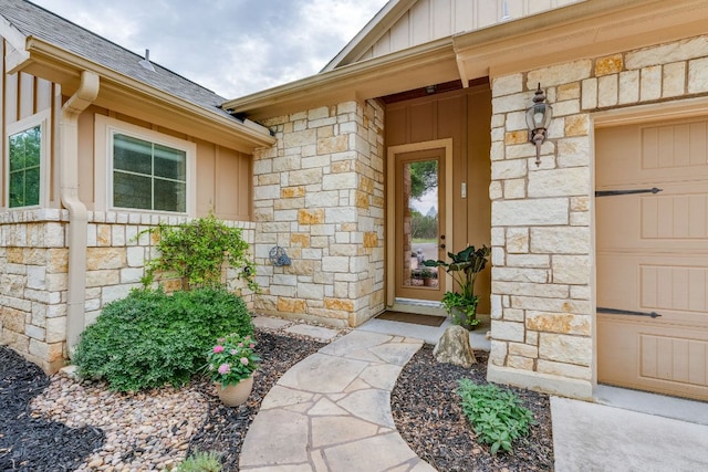 201 Thomas Ridge Rd, Burnet, TX 78611 - view of exterior entry featuring stone siding, board and batten siding, a shingled roof, and a garage