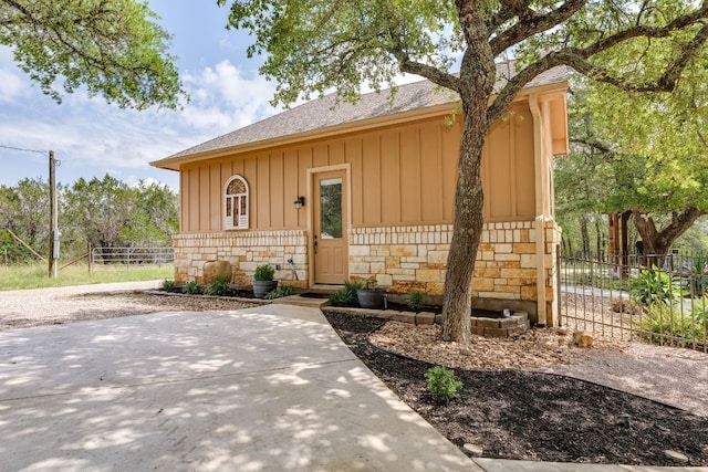 201 Thomas Ridge Rd, Burnet, TX 78611 - view of front of property with board and batten siding, stone siding, a shingled roof, and a patio