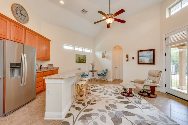 201 Thomas Ridge Rd, Burnet, TX 78611 - kitchen with stainless steel refrigerator with ice dispenser, plenty of natural light, high vaulted ceiling, and light tile patterned flooring